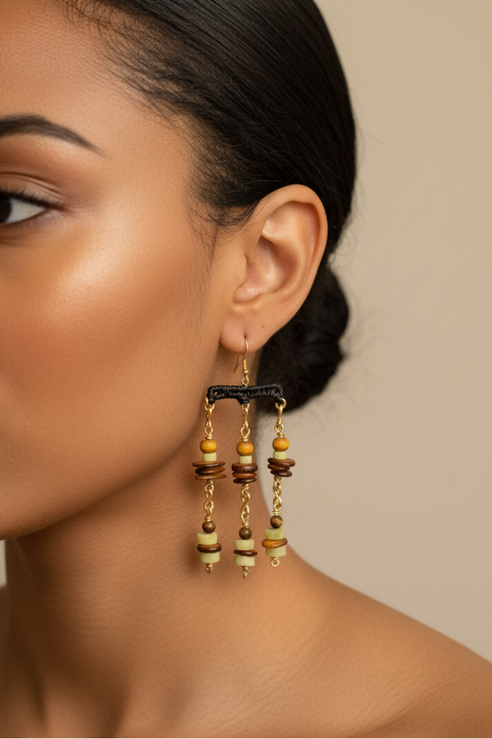 Close-up of a woman wearing gold earrings with a neutral background
